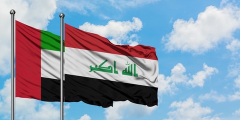 United Arab Emirates and Iraq flag waving in the wind against white cloudy blue sky together. Diplomacy concept, international relations.