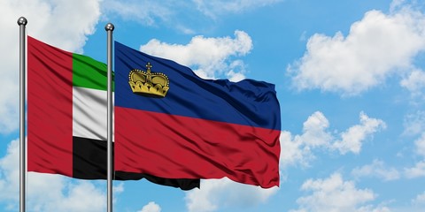 United Arab Emirates and Liechtenstein flag waving in the wind against white cloudy blue sky together. Diplomacy concept, international relations.