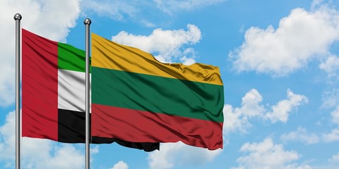 United Arab Emirates and Lithuania flag waving in the wind against white cloudy blue sky together. Diplomacy concept, international relations.