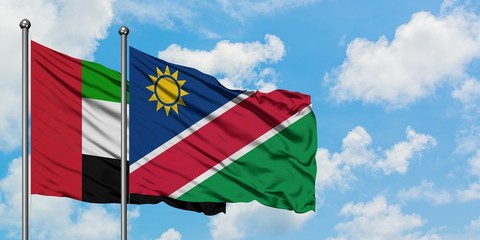United Arab Emirates and Namibia flag waving in the wind against white cloudy blue sky together. Diplomacy concept, international relations.