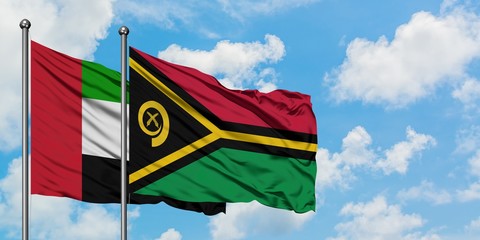 United Arab Emirates and Vanuatu flag waving in the wind against white cloudy blue sky together. Diplomacy concept, international relations.