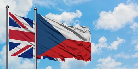 United Kingdom and Czech Republic flag waving in the wind against white cloudy blue sky together. Diplomacy concept, international relations.