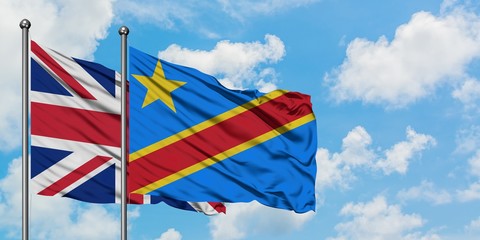 United Kingdom and Congo flag waving in the wind against white cloudy blue sky together. Diplomacy concept, international relations.