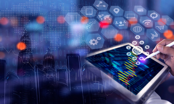 Businessman using tablet and laptop analyzing sales data and economic growth graph chart. Business strategy. Digital marketing. Double exposure.