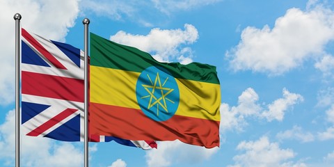 United Kingdom and Ethiopia flag waving in the wind against white cloudy blue sky together. Diplomacy concept, international relations.