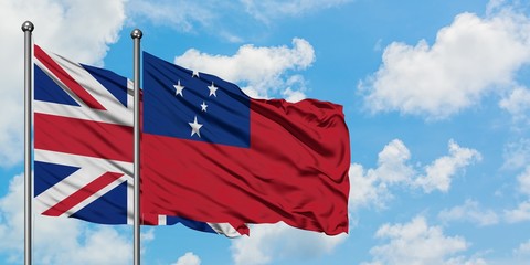 United Kingdom and Samoa flag waving in the wind against white cloudy blue sky together. Diplomacy...