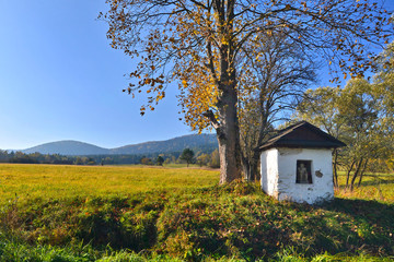 Old small chapel of Pensive Christ in autumn sunny day, Low Beskids (Beskid Niski), Poland. - obrazy, fototapety, plakaty