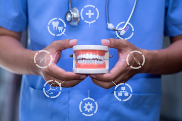 Dentistry and teeth treatment concept. Doctor in hospital with health insurance related icons in modern graphic interface icon.