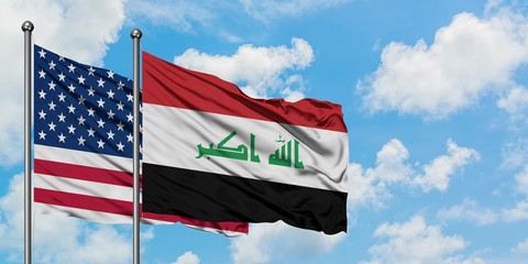United States and Iraq flag waving in the wind against white cloudy blue sky together. Diplomacy concept, international relations.