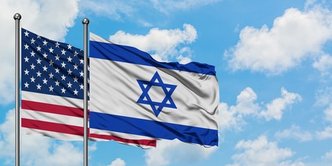 United States and Israel flag waving in the wind against white cloudy blue sky together. Diplomacy...