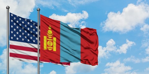 United States and Mongolia flag waving in the wind against white cloudy blue sky together. Diplomacy concept, international relations.