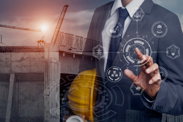 Double exposure engineering using digital technology interfaces icon with construction cranes no...