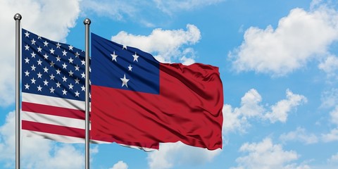 United States and Samoa flag waving in the wind against white cloudy blue sky together. Diplomacy...