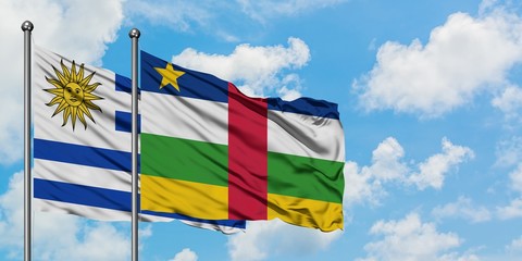 Uruguay and Central African Republic flag waving in the wind against white cloudy blue sky together. Diplomacy concept, international relations.