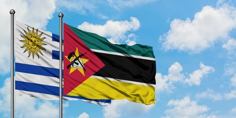 Uruguay and Mozambique flag waving in the wind against white cloudy blue sky together. Diplomacy concept, international relations.