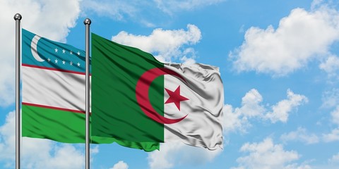 Uzbekistan and Algeria flag waving in the wind against white cloudy blue sky together. Diplomacy...