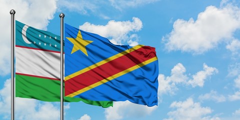 Uzbekistan and Congo flag waving in the wind against white cloudy blue sky together. Diplomacy concept, international relations.