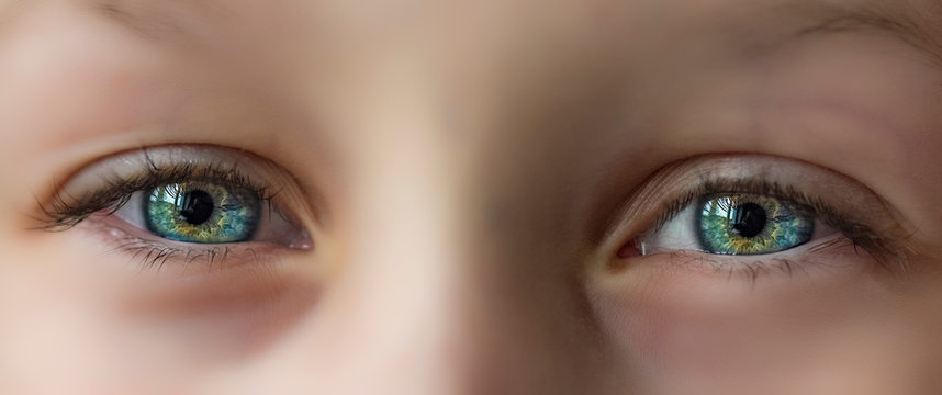 The eyes of a child are very close up.