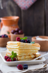 chocolate or maple syrup pouring over crepes. Closeup view of stack of thin pancakes, blini or crepes with honey