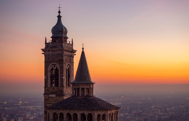 Bergamo, Italy. The old town. Amazing aerial view of the Basilica of Santa Maria Maggiore during the sunset. In the background the Po plain. Warm colors