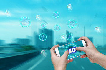 5G network interface and icon concept,hand holding mobile smart phone with cityscape