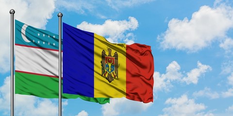 Uzbekistan and Moldova flag waving in the wind against white cloudy blue sky together. Diplomacy concept, international relations.