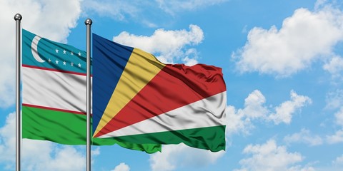 Uzbekistan and Seychelles flag waving in the wind against white cloudy blue sky together. Diplomacy concept, international relations.