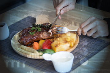 Businessman holding fork and knife eating steak, business and food/restaurant concept