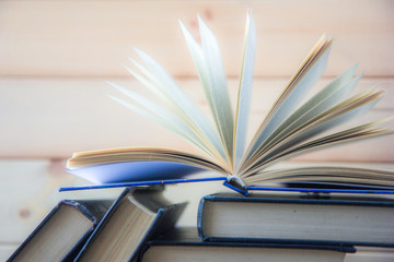Naklejka premium Stack of colorful books. Education background. Back to school. Book, hardback colorful books on wooden table. Education business concept. Copy space for text