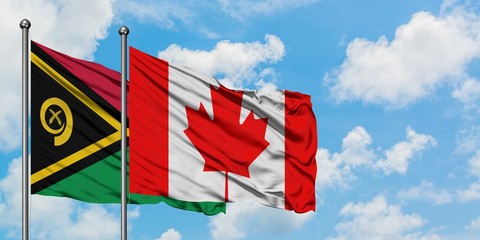 Vanuatu and Canada flag waving in the wind against white cloudy blue sky together. Diplomacy concept, international relations.