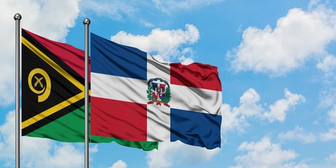 Vanuatu and Dominican Republic flag waving in the wind against white cloudy blue sky together. Diplomacy concept, international relations.