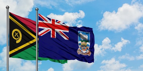 Vanuatu and Falkland Islands flag waving in the wind against white cloudy blue sky together....