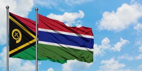 Vanuatu and Gambia flag waving in the wind against white cloudy blue sky together. Diplomacy concept, international relations.