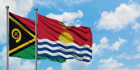 Vanuatu and Kiribati flag waving in the wind against white cloudy blue sky together. Diplomacy concept, international relations.