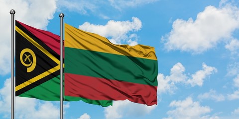 Vanuatu and Lithuania flag waving in the wind against white cloudy blue sky together. Diplomacy concept, international relations.