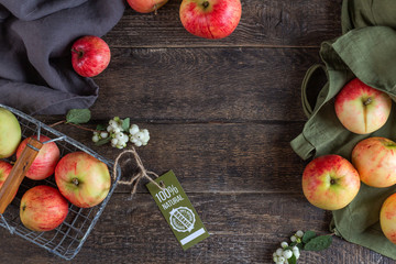 Apples and cotton bag with a label 100 natural product. Organic stuff. View from above. Close-up.