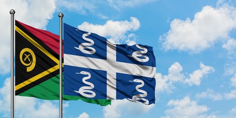Vanuatu and Martinique flag waving in the wind against white cloudy blue sky together. Diplomacy...