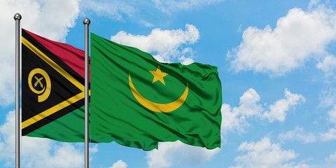 Vanuatu and Mauritania flag waving in the wind against white cloudy blue sky together. Diplomacy...