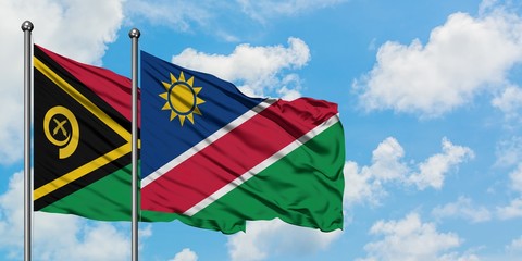 Vanuatu and Namibia flag waving in the wind against white cloudy blue sky together. Diplomacy...