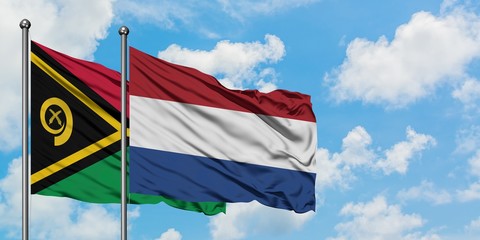 Vanuatu and Netherlands flag waving in the wind against white cloudy blue sky together. Diplomacy concept, international relations.