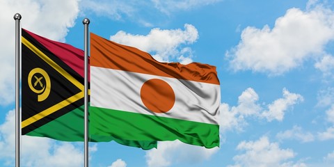 Vanuatu and Niger flag waving in the wind against white cloudy blue sky together. Diplomacy...