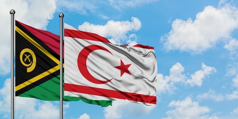 Vanuatu and Northern Cyprus flag waving in the wind against white cloudy blue sky together....