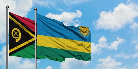 Vanuatu and Rwanda flag waving in the wind against white cloudy blue sky together. Diplomacy concept, international relations.