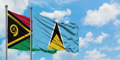 Vanuatu and Saint Lucia flag waving in the wind against white cloudy blue sky together. Diplomacy concept, international relations.