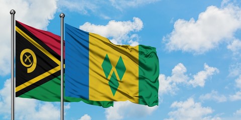 Vanuatu and Saint Vincent And The Grenadines flag waving in the wind against white cloudy blue sky...