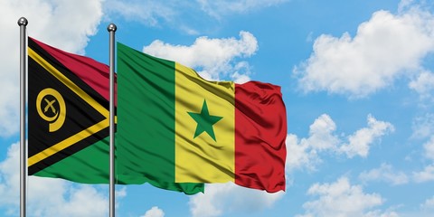 Vanuatu and Senegal flag waving in the wind against white cloudy blue sky together. Diplomacy concept, international relations.