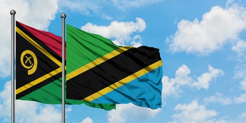 Vanuatu and Tanzania flag waving in the wind against white cloudy blue sky together. Diplomacy concept, international relations.