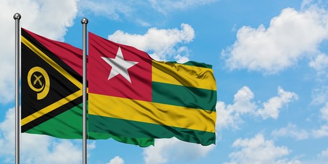 Vanuatu and Togo flag waving in the wind against white cloudy blue sky together. Diplomacy concept, international relations.