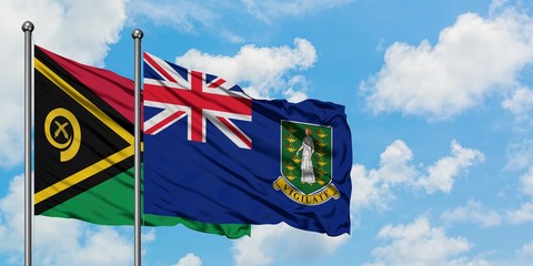 Vanuatu and British Virgin Islands flag waving in the wind against white cloudy blue sky together....