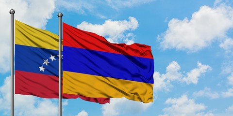 Venezuela and Armenia flag waving in the wind against white cloudy blue sky together. Diplomacy concept, international relations.